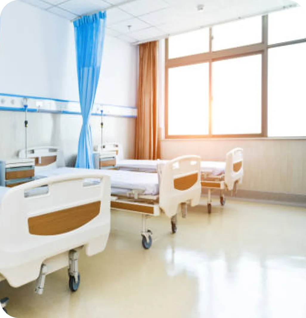 A bright, modern hospital ward with hospital beds and natural light